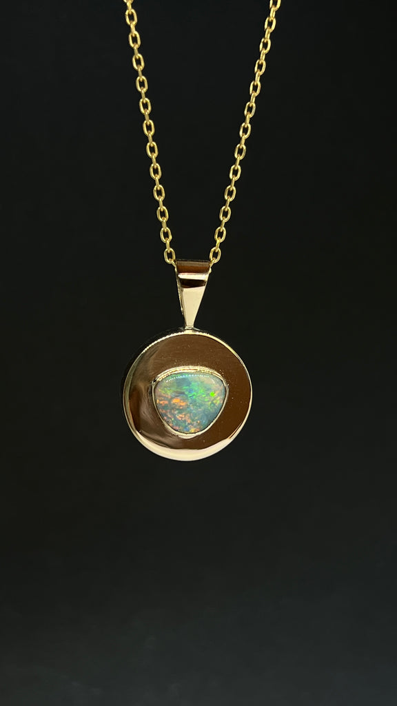 This Vintage pendant has a stunning solid Australian Opal centrepiece, set into a circle of highly polished 9ct gold. 