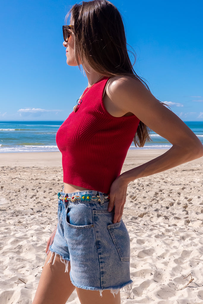 The Astro Really Red Knit Tank Top is a luxurious berry red tank top. The tank top features a high neck, stretchy knit fabric, ribbed texture and is fitted. 