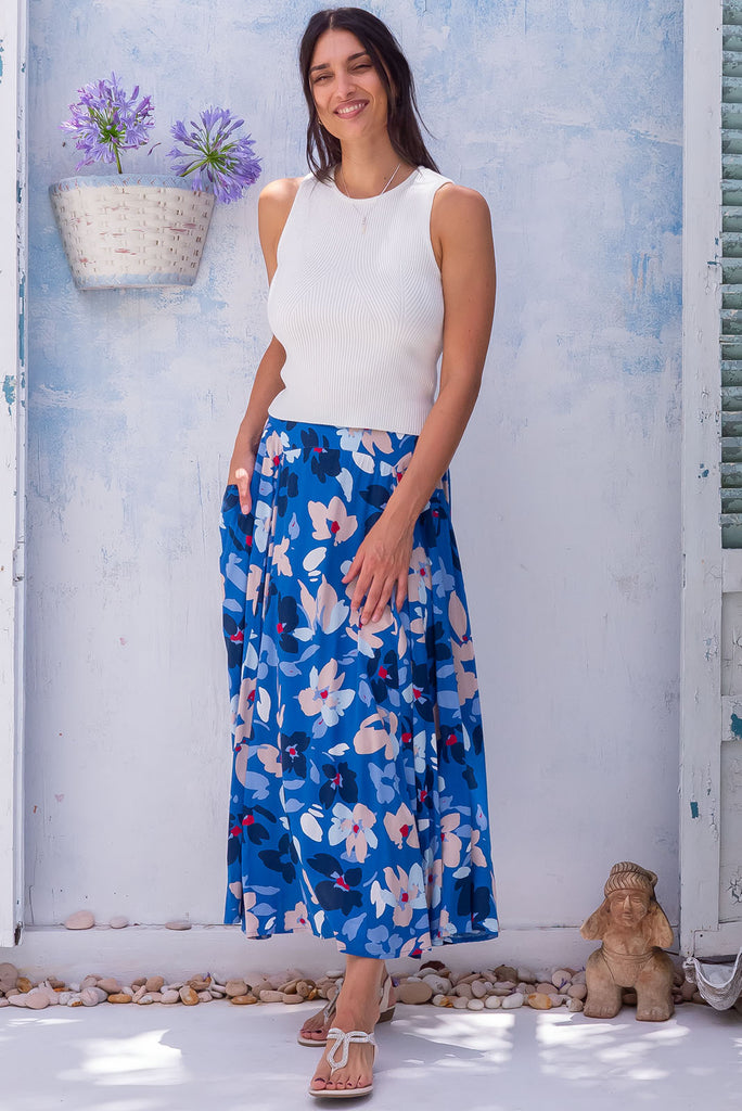 The Atlantis Blue Blooms Maxi Skirt is a beautiful dark blue based maxi skirt with a large floral print in blues and whites. The skirt features a double v-shaped waist yoke, inset panels on the front from the yoke down, very full skirt, elasticated back of waist and side pockets. This is a slip on design with a shapely hemline and slightly longer front due to the inset panels. Made from 100% rayon.