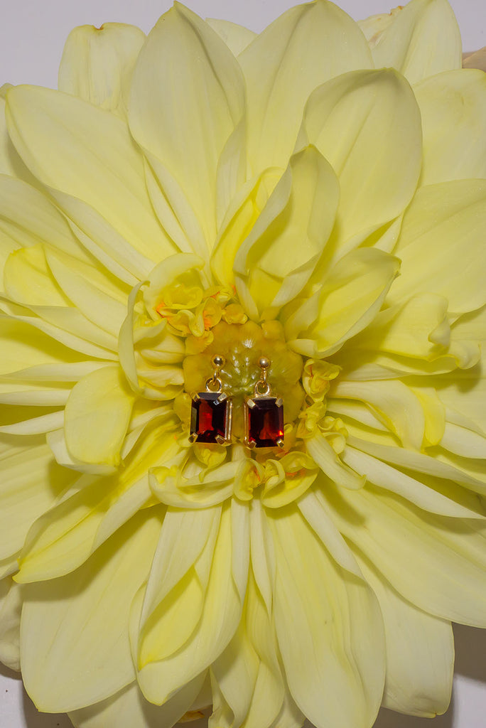 These gorgeous deep red sparkling Garnet earrings are both romantic and chic.&nbsp; Sophisticated earrings with an emerald cut Garnet gemstones set in 9ct gold vermeil. Made exclusively for Mombasa Rose Boutique.