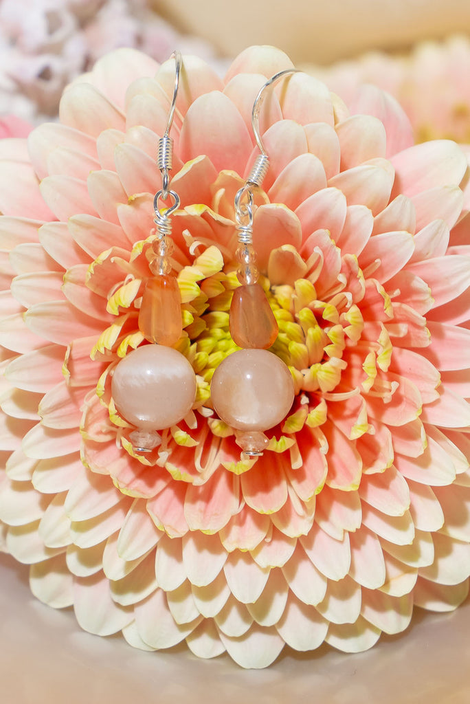The Earrings Silver Droplet Cats Eye & Carnelian are a gorgeous pair of handmade earrings made with natural sunstone, carnelian, and created cats eye.