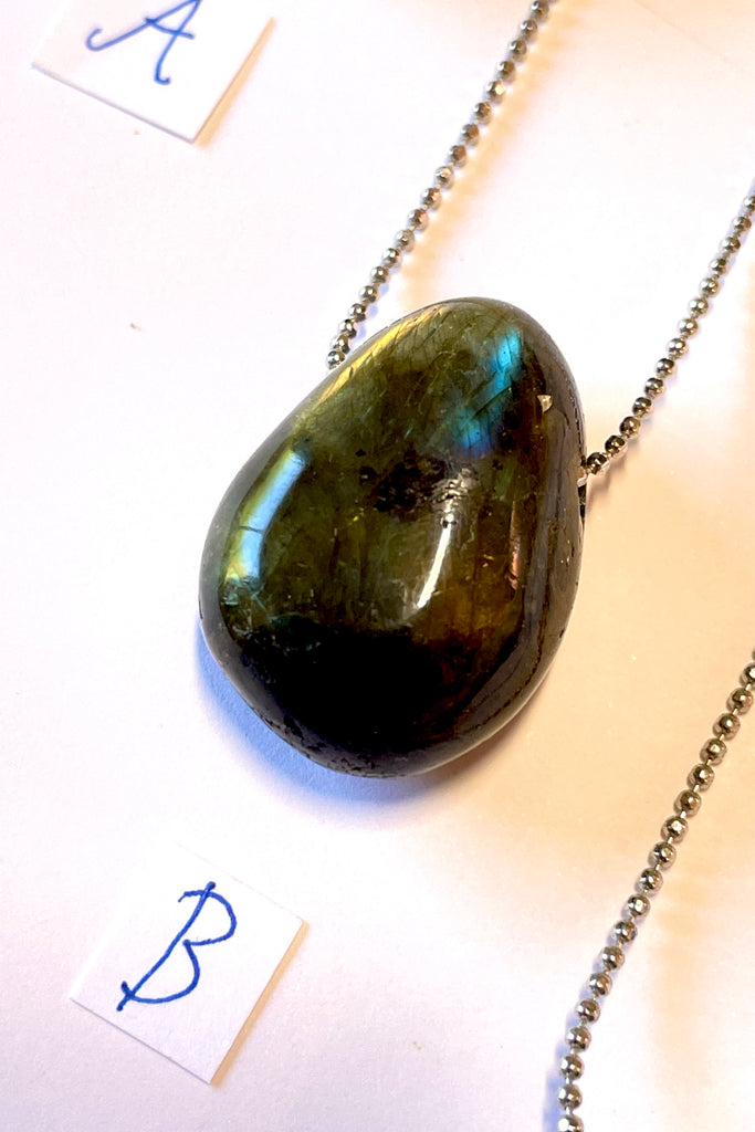 The Pendant Pebble Pop Labradorite is a smooth polished piece of the mystical gemstone Labradorite, it is a natural semi precious stone. Labradorite is considered a tremendously spiritual stone,