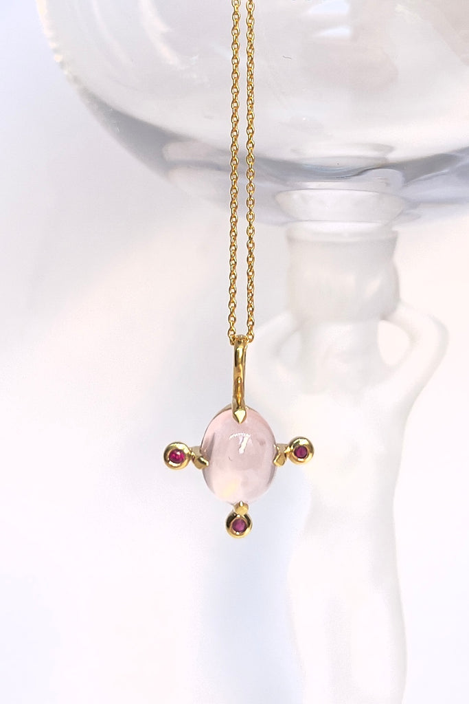 Pendant and chain are 9ct gold vermeil on a base of 925 silver, the gold is 2.5microns thick so will never rub or discolor An oval cabochon cut Rose Quartz gemstone set in 9ct gold vermeil. Side stones are deep pink Sapphires.
