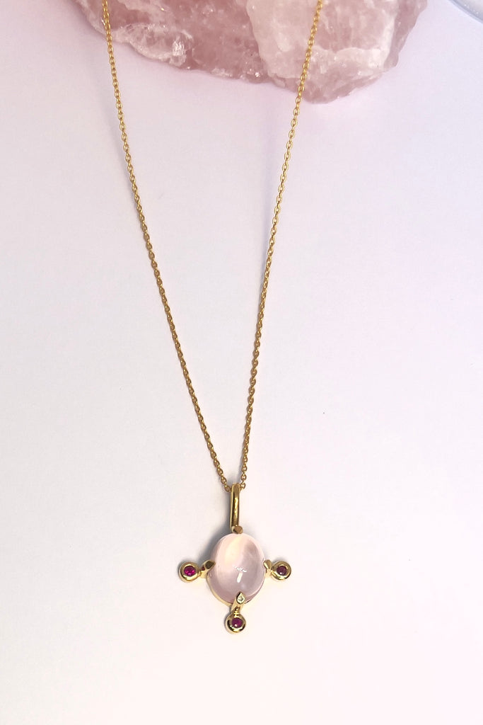 Pendant and chain are 9ct gold vermeil on a base of 925 silver, the gold is 2.5microns thick so will never rub or discolor An oval cabochon cut Rose Quartz gemstone set in 9ct gold vermeil. Side stones are deep pink Sapphires.
