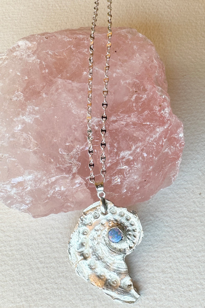 Made exclusively for Mombasa Rose Boutique. Cast and designed by North Shore Opals Studio, Australia. The natural Australian Opal was cut and polished by the master cutter in Noosa at the  North Shore Studio. The silver shell is 4.2cm long. This pendant is very delicate and incredibly pretty