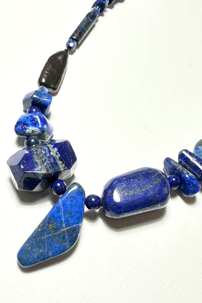 The necklace is made with different shapes of natural blue Lapis Lazuli beads with a highlight of two grey pearls