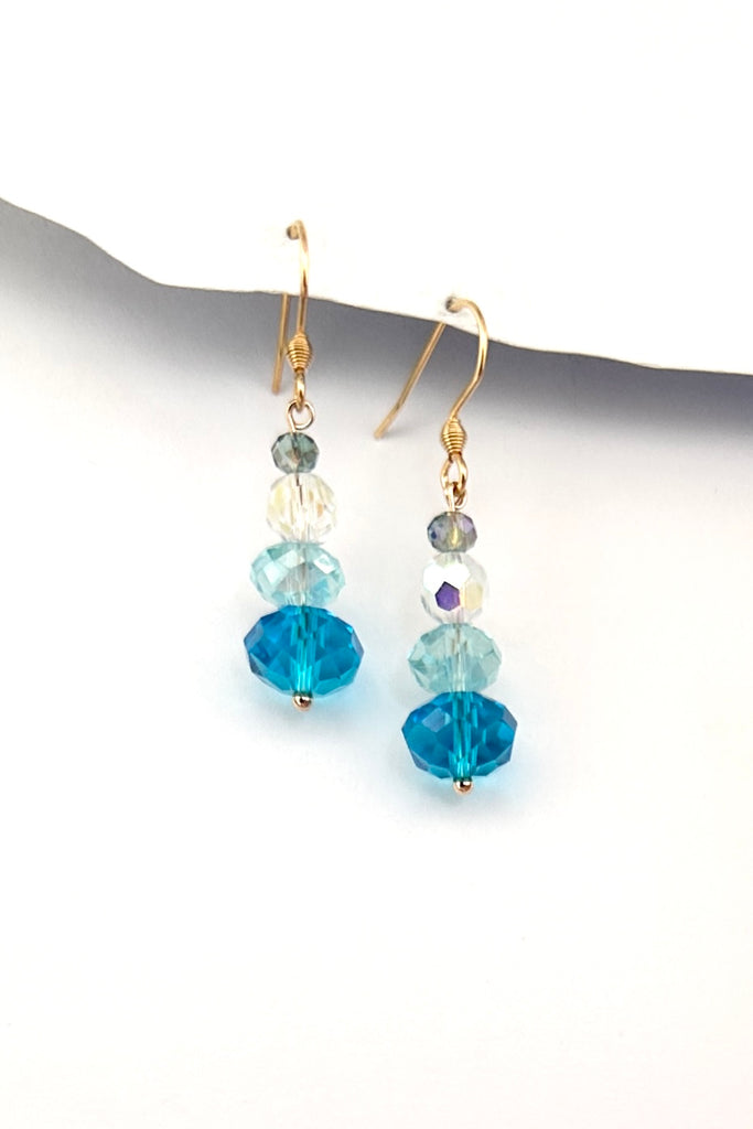 Chic earrings that are a dainty stack of sparkling crystal beads that swing from a goldtone hook. 