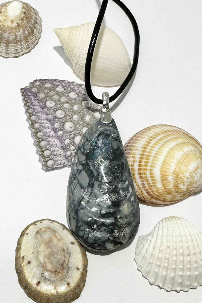 A mussel shell carved from Australian Opal Potch rock, there is a small trace of blue green opal at the top of the shell.  Responsible Sourcing. A one off piece, it was cut and polished in Noosa Australia., this is a very special and powerful piece.