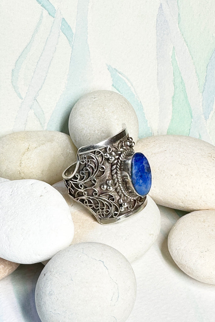 An unusual ring with a pretty cobalt blue Lapis Lazuli stone set in the centre, surrounding the stone is delicate silver filigree. The inside of the band is very smooth so it is comfortable to wear.