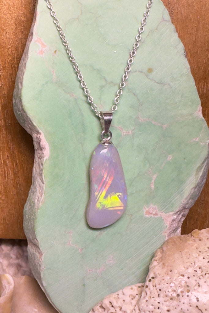 This quirky little opal pendant resembles a footprint left in the sand. It has a rolling rainbow flash down the stone. 