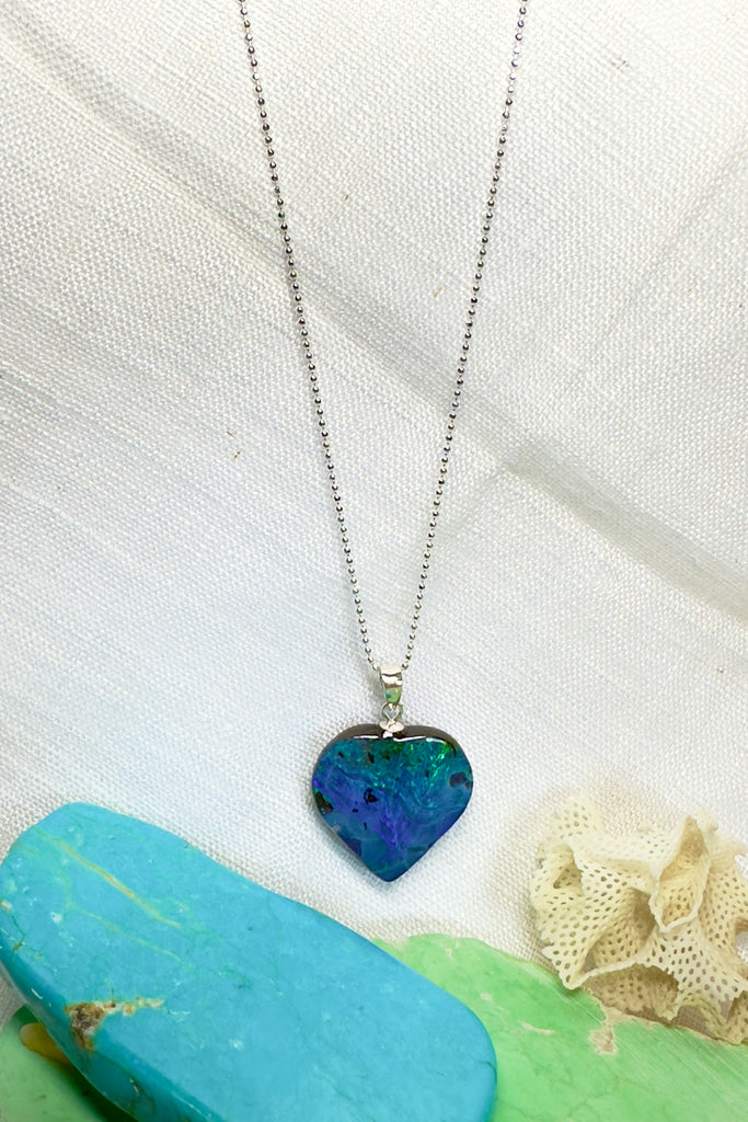 A gorgeous Australian boulder opal heart pendant, one could be looking at an ocean reef from above, deep blue sea and tiny islands.