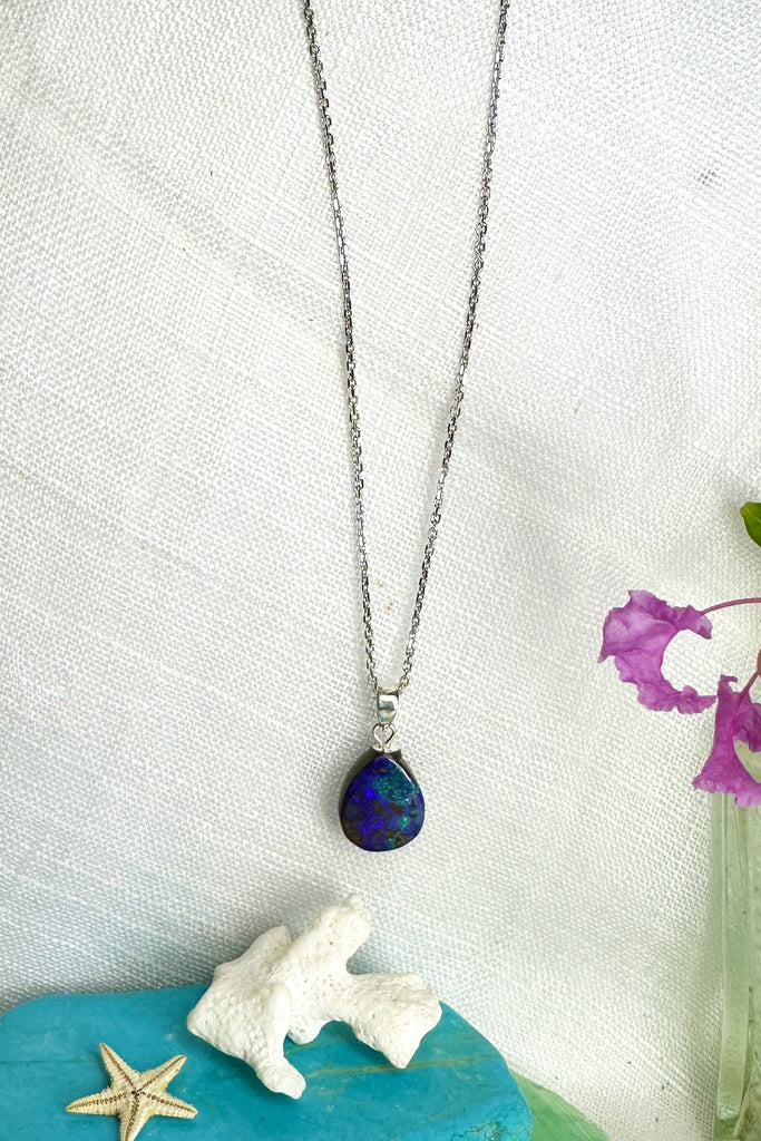 A tiny splash of deep blue and green on this subtle opal pendant one could be looking at an ocean reef from above, deep blue sea and tiny islands.