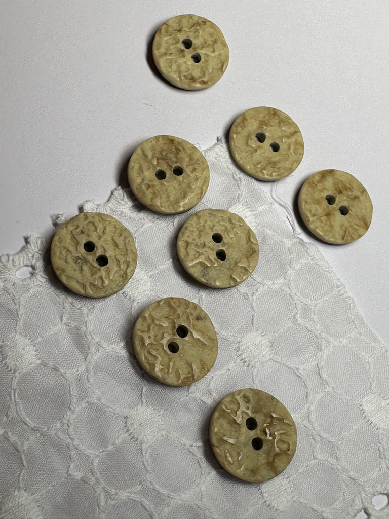 These buttons have a very earthy look, one side is a coconut composite material, the other side has a ripple effect. Great for any sewing or craft project.