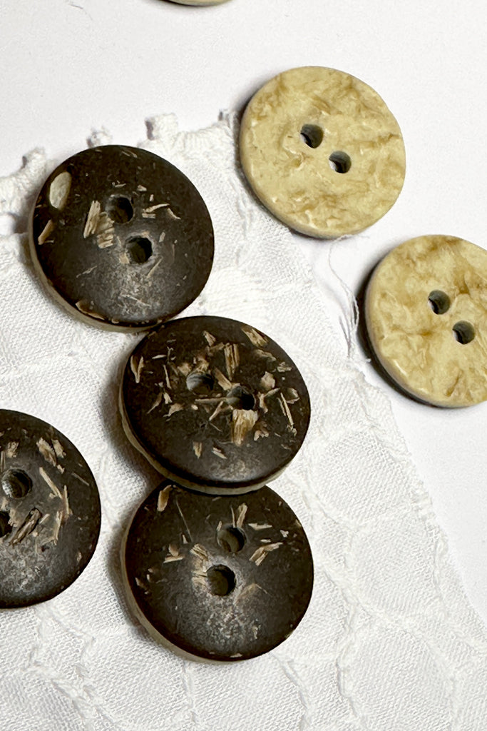 These buttons have a very earthy look, one side is a coconut composite material, the other side has a ripple effect. Great for any sewing or craft project.