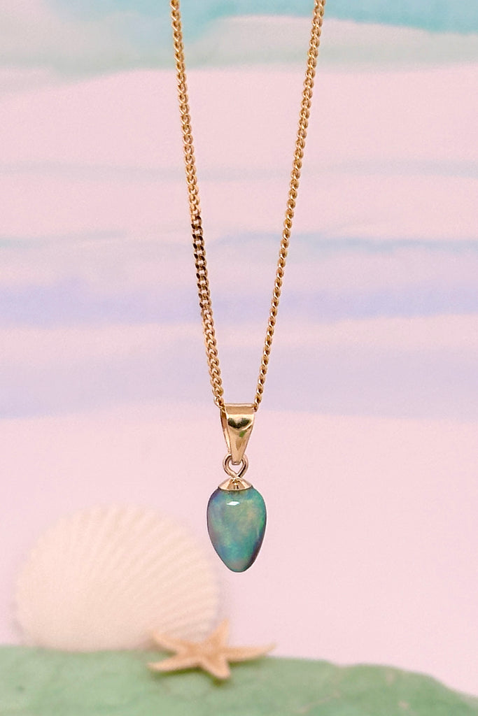 tiniest delicate opal pendant, very bright sea green and blue washes across the stone, this is perfection