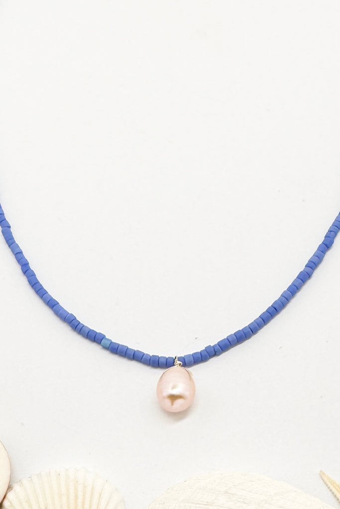 So pure so chic and modern, a lustrous drop pearl hangs from a necklace of sky blue seed beads.