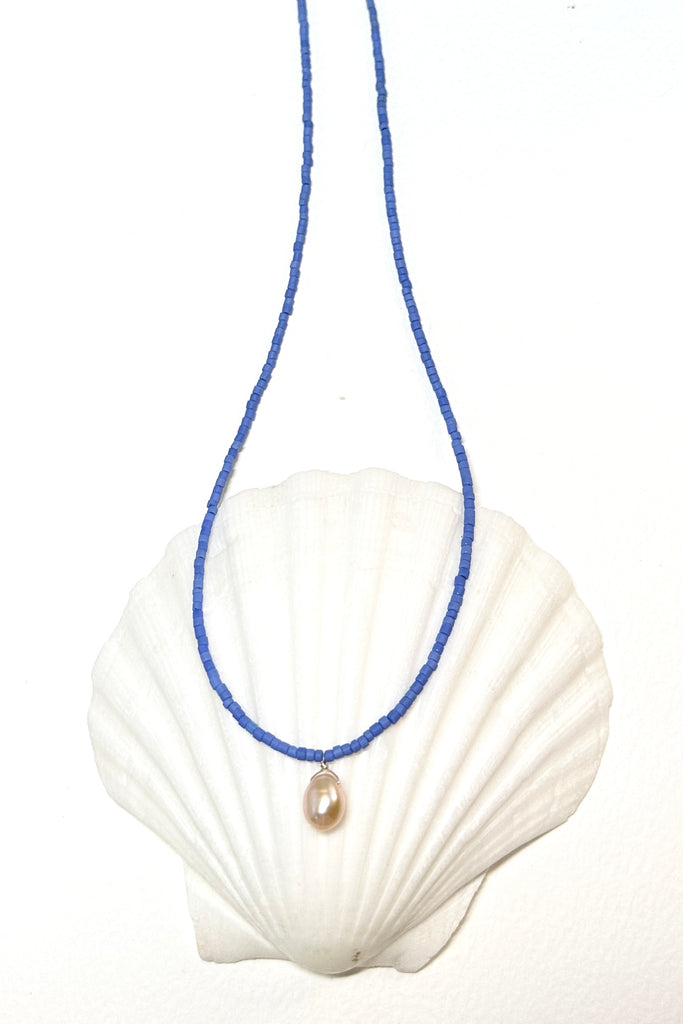 So pure so chic and modern, a lustrous drop pearl hangs from a necklace of sky blue seed beads.