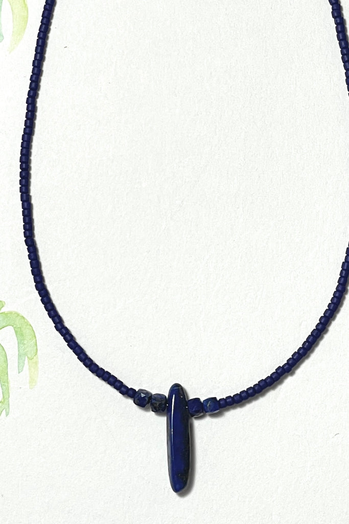  A delicate choker style necklace made with Afghan heishi seed beads, with small shiny side pearls and assorted polished Lapis Lazuli beads as the centrepiece.