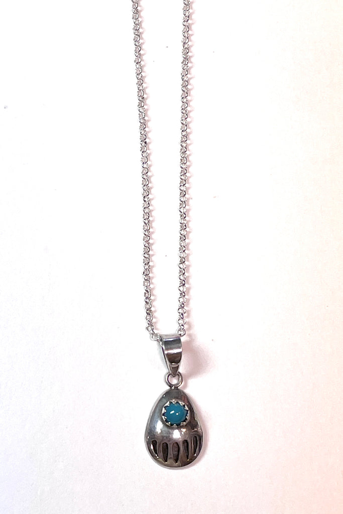 A perfect little silver bear paw pendant with a natural turquoise cabochon set in 925 silver. an absolutely perfect festive gift.