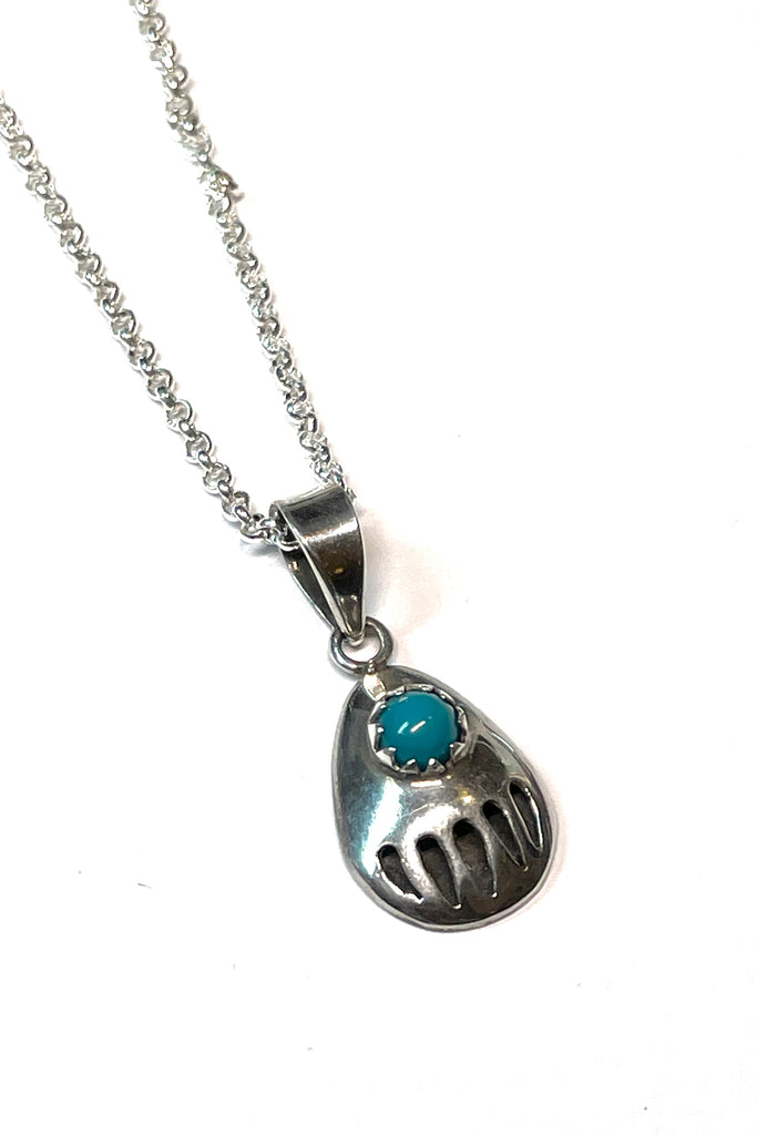 A perfect little silver bear paw pendant with a natural turquoise cabochon set in 925 silver. an absolutely perfect festive gift.