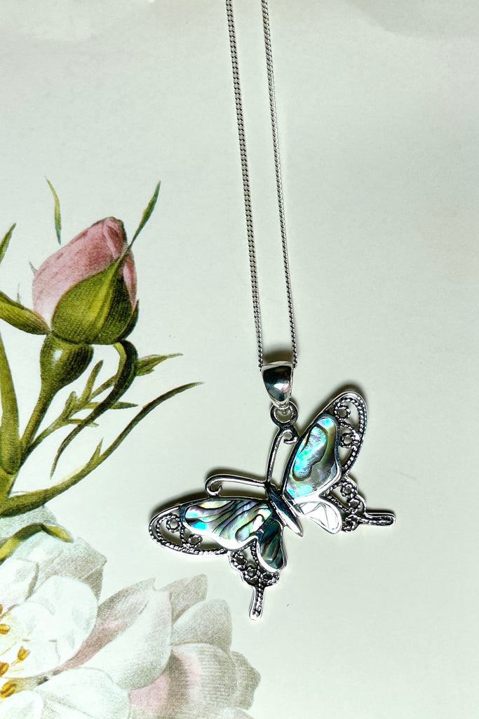 A charming butterfly necklace in shiny silver, with inlaid Mother of Pearl shell in palest pink..  