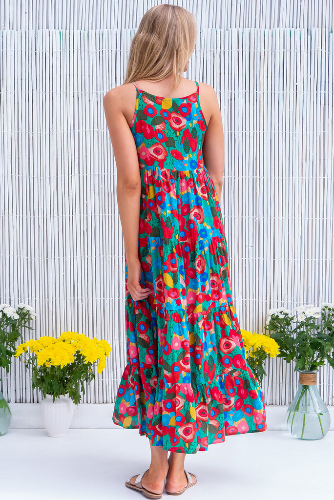The Lulu Darling Green Floral Maxi Dress is a gorgeous green dress with a bright, multicoloured abstract floral print. The maxi dress features a high neck, high cut under the arms, full tiered skirt falling from under bust, side pockets, and is woven cotton/rayon blend. 
