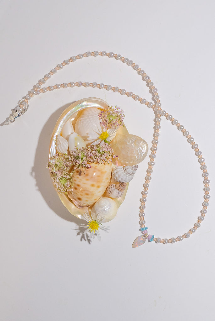 As dainty and delightful as a sea sprite, this gorgeous tiny crystal opal pendant with green, red&nbsp; and blue flashes is strung on a necklace of small pearls with citrine gemstone highlights.