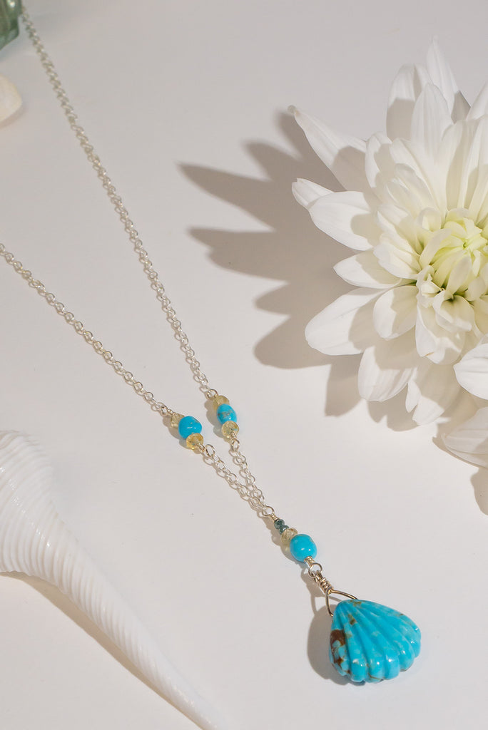 The perfect style for lovers of the sea. This beautiful handmade necklace features a delicate carved turquoise scallop shell pendant.