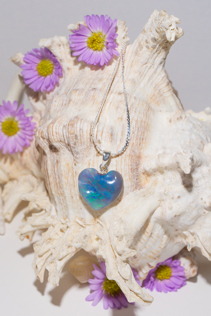 truly unique piece showing the colours of its ancient past on the undulating surface, a semi black heart shaped opal pendant