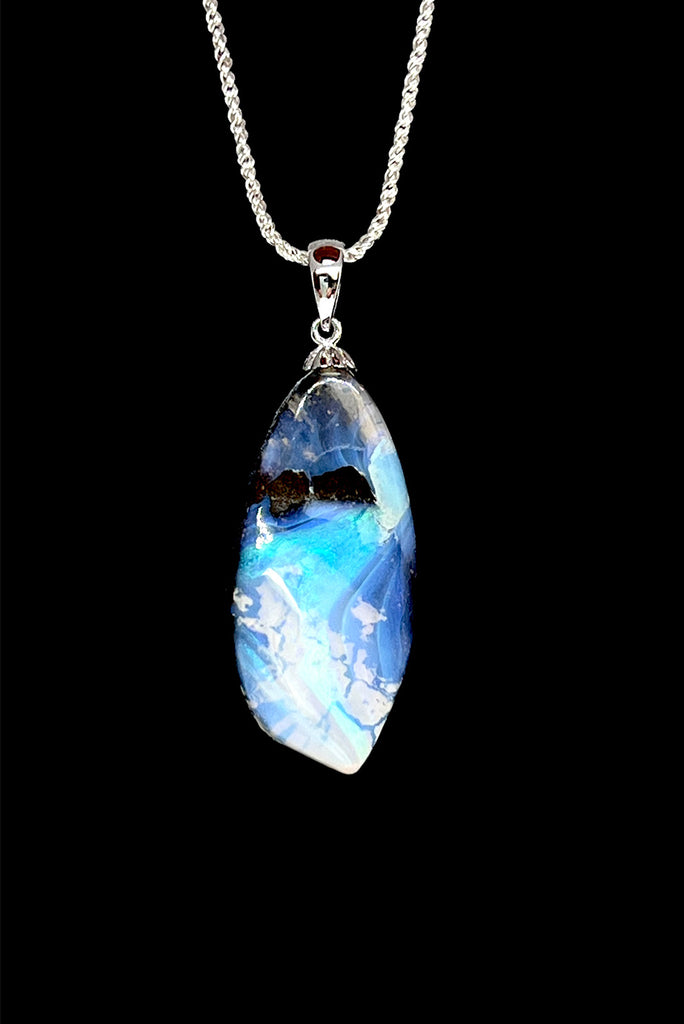 An organic natural piece featuring a small clear jelly opal detail on one side that reveals what is underneath. This piece has so much detail and depth.