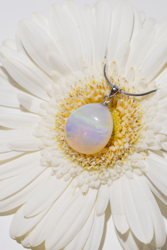 Absolute perfection, this lovely round stone looks like a pale misty moon, with soft blue, pale greeny yellow and tiny flashes of pink. The detail is across the stone and deep within, it is polished to a lovely soft finish. This piece has so much mystery. Australian Crystal Opal.