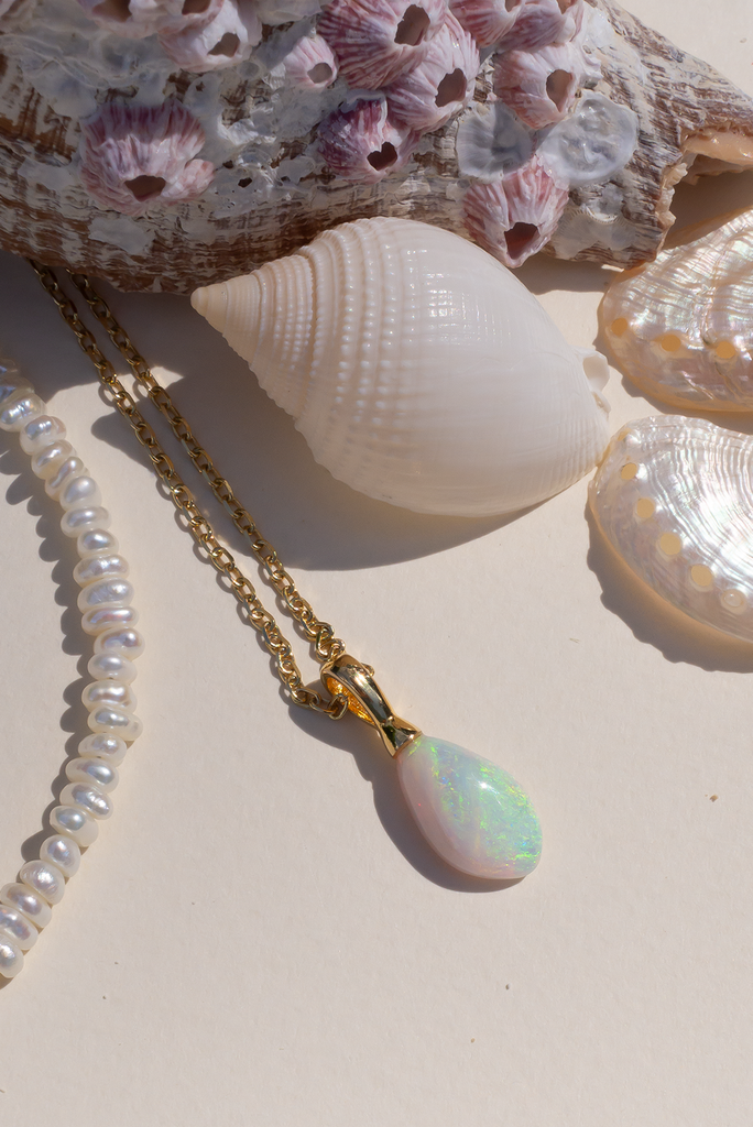 This is a really lovely opal pendant the crystal has flecks and shimmer in pink, green, blue and gold, the shape is very pure and harmonious.