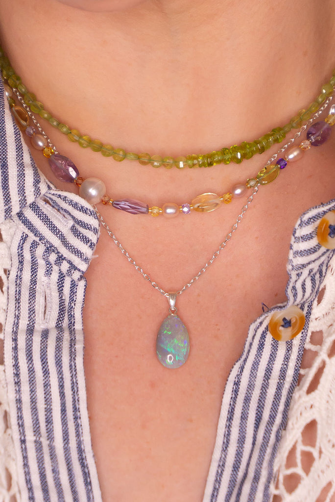 Bright green and mauve swirling through the mystical silvery grey landscape, this opal pendant is very natural and gentle in colour and shape.