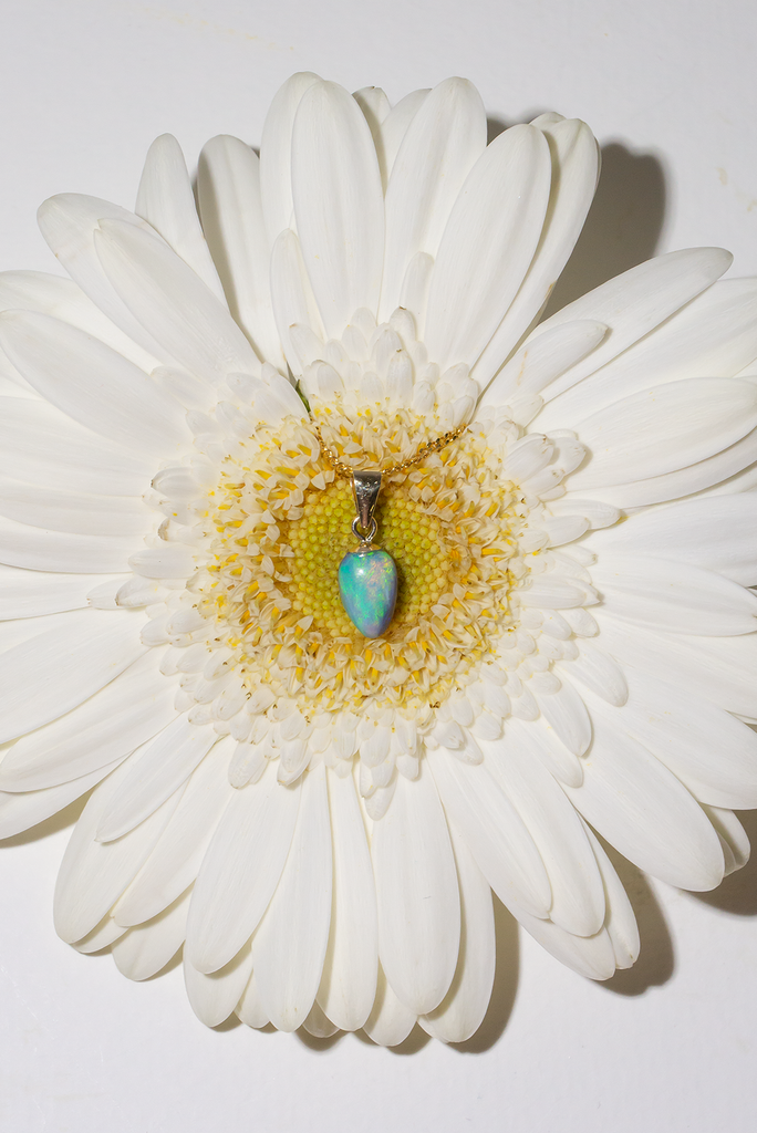 tiniest delicate opal pendant, very bright sea green and blue washes across the stone, this is perfection