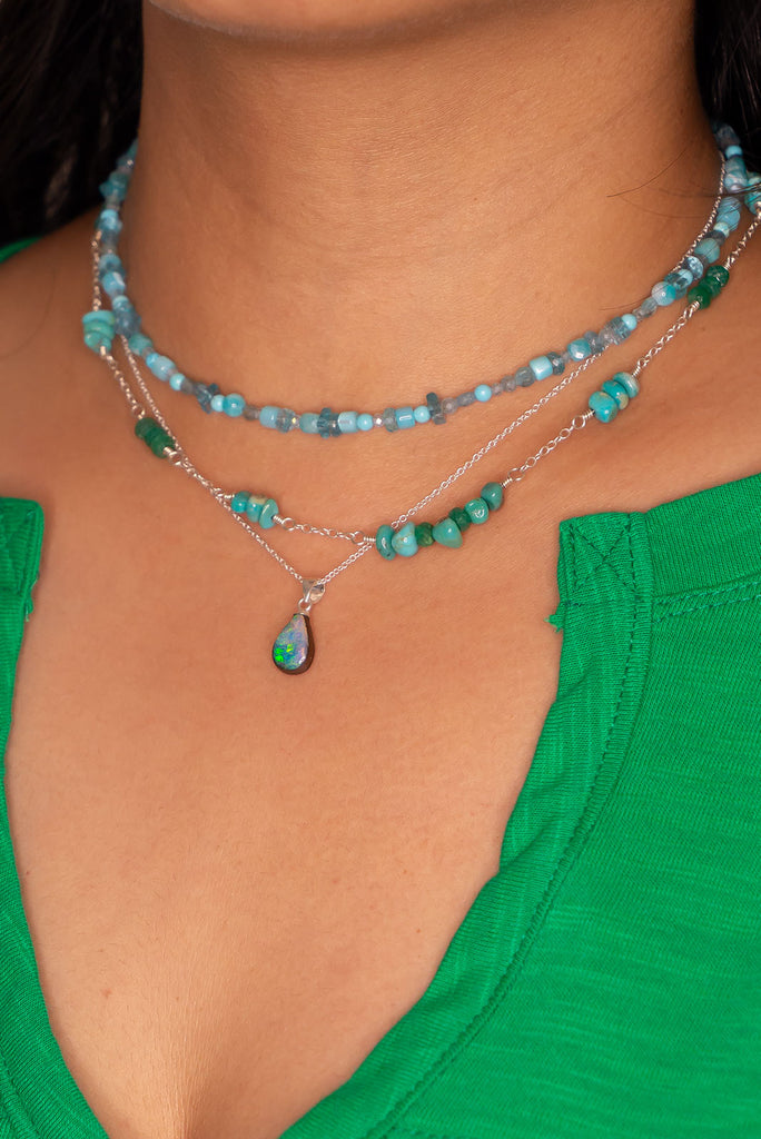 A tiny splash of cool crystal water, a splash of summer rain on green grass, this little opal pendant with its blues and greens is perfect.