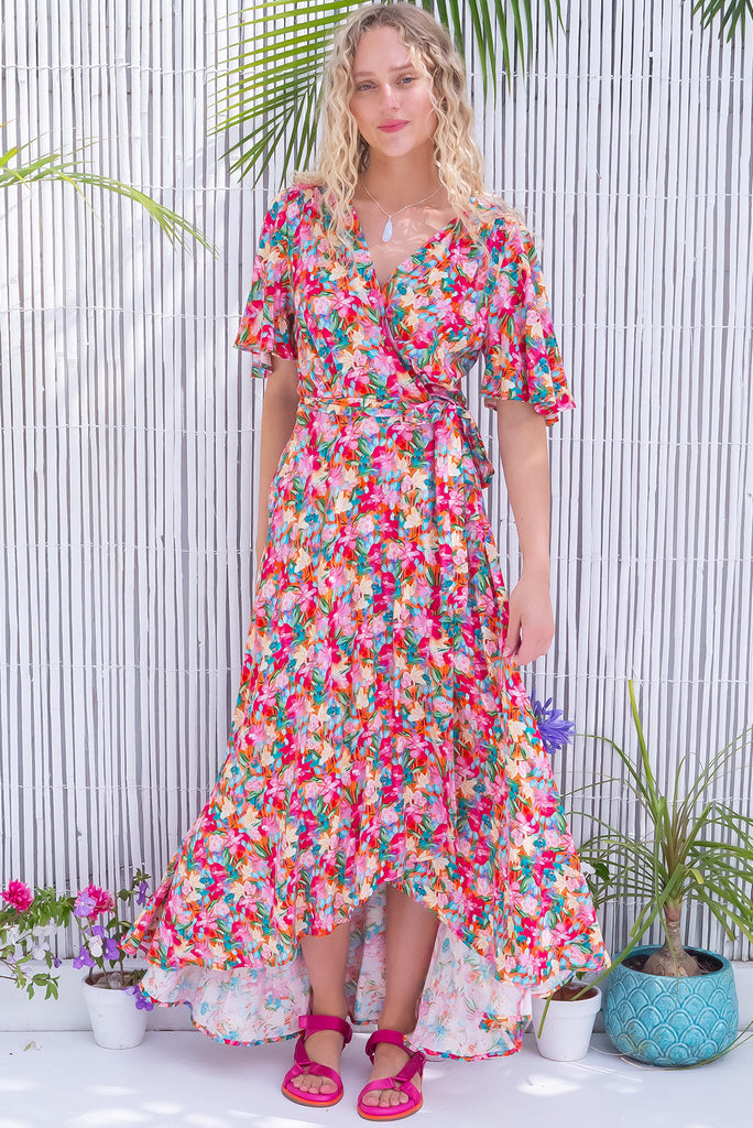 The Petal Pink Paint Maxi Wrap Dress is a gorgeous wrap style maxi dress in a multicoloured brushstroke floral print. The dress features flutter sleeves, a functional wrap design, and side pockets. Made from 100% rayon.