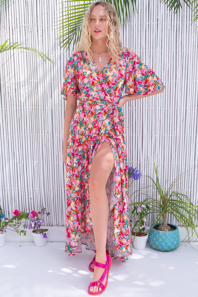 The Petal Pink Paint Maxi Wrap Dress is a gorgeous wrap style maxi dress in a multicoloured brushstroke floral print. The dress features flutter sleeves, a functional wrap design, and side pockets. Made from 100% rayon.