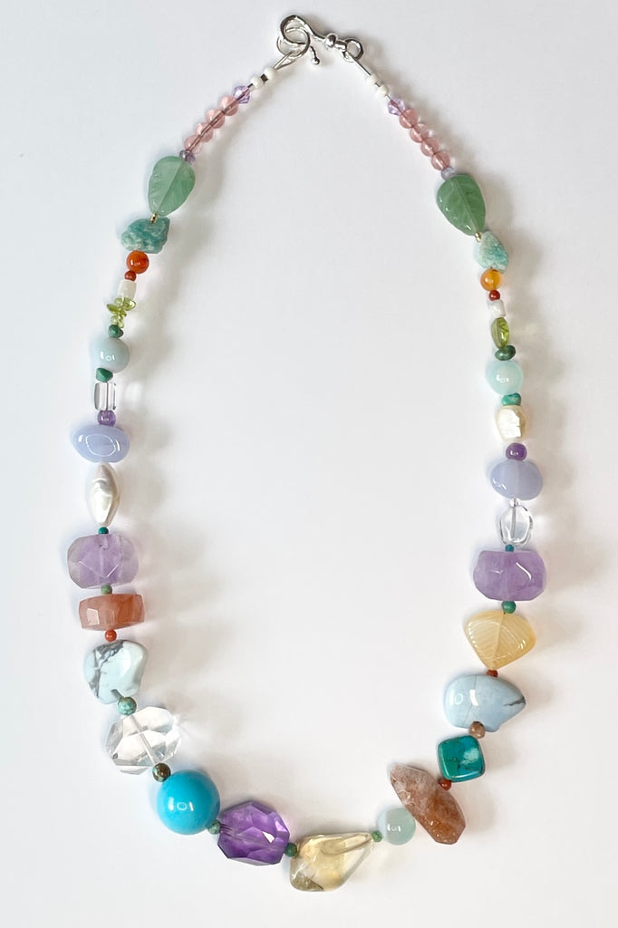 The necklace features two hand carved Zuni bears bought in Tucson Arizona. Stones are Natural Turquoise, Pearl, Amethyst, Carnelian, Clear Rock Crystal Blue Lace Agate,. Citrine, Mother of Pearl shell, Strawberry Quartz and Peridot. 