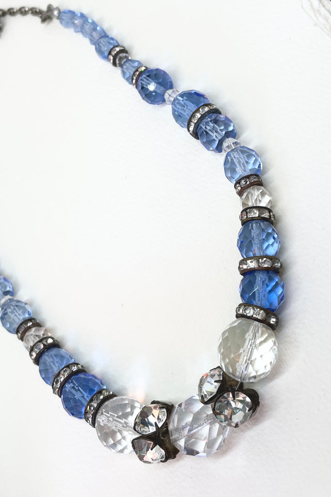This beautiful necklace is made with crystal beads in a lovely clear blue colour, and three large clear crystal faceted beads. There are old diamante spacers