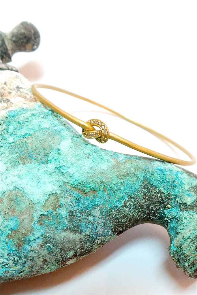 This adorable bangle has Luna appeal it is handcrafted in gold plated  silver vermeil. The gems are studded randomly and will sparkle at different angles