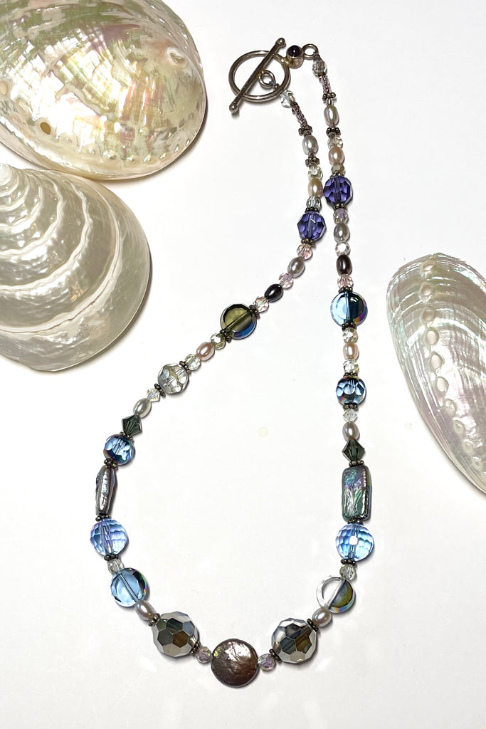 This beautiful necklace is made with vintage crystal beads in a lovely clear blue colour, and also new crystal beads. It also has grey pearls and palest pink pearls. 