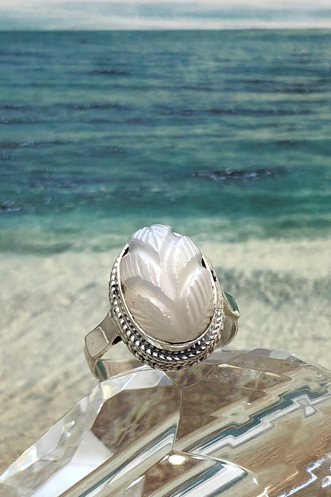 The Echo Ring Moonstone Carving is a handmade moonstone cabachon ring featuring set in silver with a hand carved leaf design.