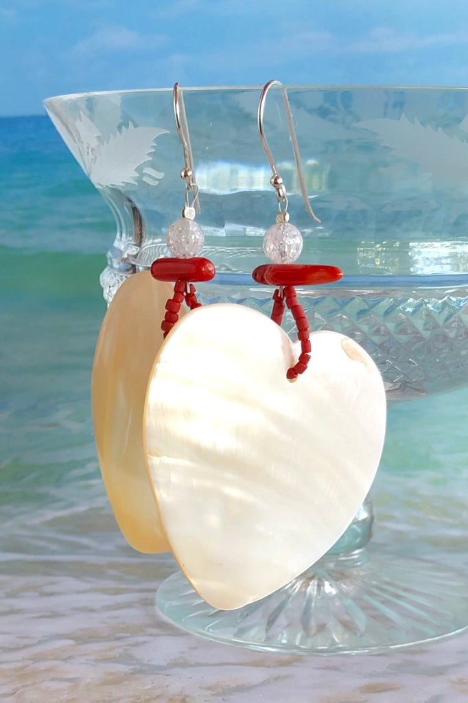 The polished Mother of Pearl shell has been hand cut into a heart shape then polished. The detal is of Red Bamboo coral, crackle rock crystal and handmade sand beads, the hook is silver.