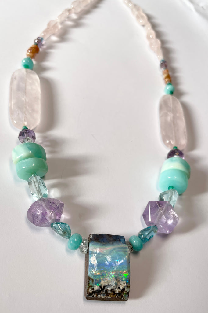 This necklace is one of the first pieces showcasing the opal cutting and jewellery designs from North Shore Opals Australia.  The centrepiece is cut from an opal "split" so the surface is not polished but left exactly as it has been for millions of years.