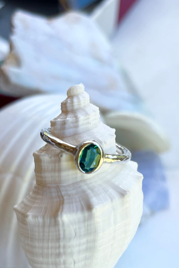 The hammered band on this ring has a slightly textured finish, giving it a hand made feel, complementing the beautiful 6x4mm natural blue tourmaline gemstone set into the ring. A very modern and striking design.