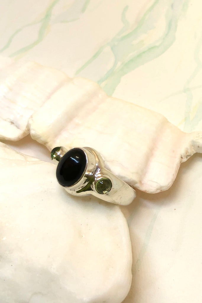 Echo Ring Onyx and Peridot is a powerful silver ring with black onyx cabachon set in 925 silver with Peridot side stones.