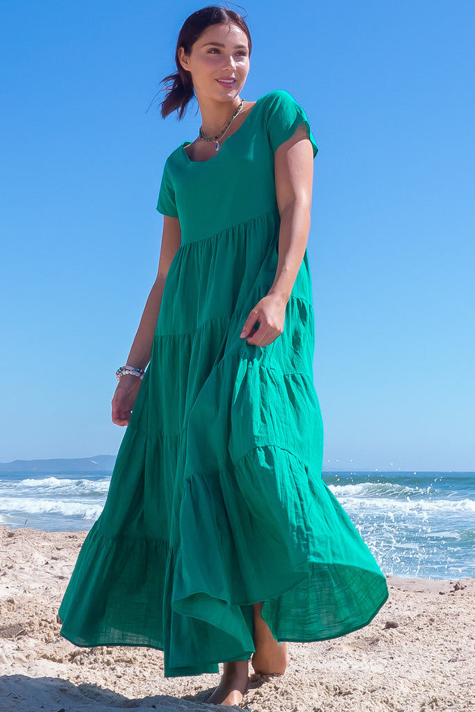 The Lucky Lulu Jade Tiered Maxi Dress is a gorgeous jade green maxi dress. This dress features a scooped neckline, adjustable waist tabs, side pockets and a wide tiered skirt. Made from woven 100% cotton.
