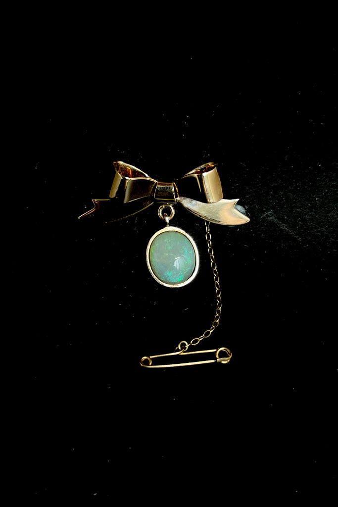 This Vintage Solid Opal and 9ct Gold Bow Brooch is just too sweet! The pretty little gold bow neatly holds the drop of Opal. This interesting pre-loved piece is in very good condition.