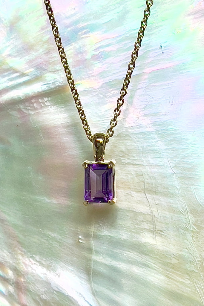 The pendant and chain are 9ct gold vermeil on a base of 925 silver, the gold is 2.5microns thick so will never rub or discolor An Amethyst emerald cut gemstone set in 9ct gold vermeil. Pendant is 4cm long. Chain is gold vermeil