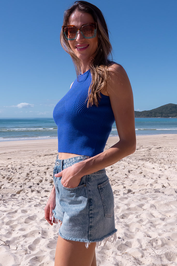 The Astro Cabo Blue Knit Tank Top is a luxurious blue tank top. The tank top features a high neck, stretchy knit fabric, ribbed texture and is fitted. 